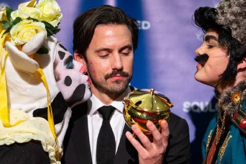Actor Milo Ventimiglia (C) looks at his Pudding Pot trophy while he is kissed by Hasty Pudding Theatricals cast members at a press conference after he was honored as the Harvard University Hasty Pudding Theatricals 2019 Man of the Year at Harvard University in Cambridge, Massachusetts on February 8, 2019.  BOS20190208111 MATTHEWxHEALEY