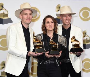 Tim Hanseroth and Phil Hanseroth with Brandi Carlisle (C) appear backstage with her awards for Best American Roots Song for The Joke, Best Americana Album for By The Way, I Forgive You, and Best American Roots Performance for The Joke, during the 61st annual Grammy Awards held at Staples Center in Los Angeles on February 10, 2019.  LAP201902101038 GREGGxDEGUIRE