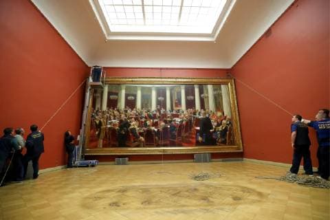 ST PETERSBURG, RUSSIA - FEBRUARY 11, 2019: Russian Museum workers take a painting by Ilya Repin, Ceremonial meeting of the State Council of 7 May 1901 on the day of the Centenary of its Establishment , off its stretcher in Mikhailovsky Castle (St Michael s Castle) as it is prepared to be shipped to Moscow for a Tretyakov Gallery exhibition marking Ilya Repin s 175th birthday anniversary. Peter Kovalev TASS  TS0A08F9