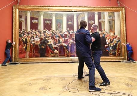 ST PETERSBURG, RUSSIA - FEBRUARY 11, 2019: Russian Museum workers take a painting by Ilya Repin, Ceremonial meeting of the State Council of 7 May 1901 on the day of the Centenary of its Establishment , off its stretcher in Mikhailovsky Castle (St Michael s Castle) as it is prepared to be shipped to Moscow for a Tretyakov Gallery exhibition marking Ilya Repin s 175th birthday anniversary. Peter Kovalev TASS  TS0A092E
