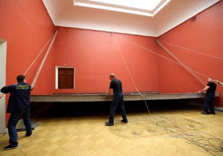 ST PETERSBURG, RUSSIA - FEBRUARY 11, 2019: Russian Museum workers take a painting by Ilya Repin, Ceremonial meeting of the State Council of 7 May 1901 on the day of the Centenary of its Establishment , off its stretcher in Mikhailovsky Castle (St Michael s Castle) as it is prepared to be shipped to Moscow for a Tretyakov Gallery exhibition marking Ilya Repin s 175th birthday anniversary. Peter Kovalev TASS  TS0A0930