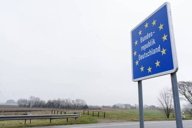 Denmark Wild boar border fence Denmark Tonder 14 02 2019 A sign with the inscription Federal Republic of Germany at the Danish-German border In the background is the fence against wild boars from Germany Anti swine fever fence in the test phase Background is the highly contagious African swine fever Tonder Syddanmark which has been spreading since 2014 Denmark