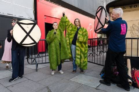 February 17, 2019 - London, Greater London, United Kingdom - Activists from Extinction Rebellion wear coats made of living grass during a demonstration outside London Fashion Week on 17 February, 2019. Protesters call for the British Fashion Council to influence fashion industry to stop the trend of excessive consumption and unsustainable growth in the face of climate change and ecological collapse. Textiles production contributes 1.2 billion tonnes of carbon emissions annually and textiles are the largest single source (34.8%) of microplastic pollution affecting marine life. London United Kingdom  - ZUMAn230 20190217_zaa_n230_195 Copyright: xWiktorxSzymanowiczx