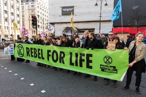 February 17, 2019 - London, Greater London, United Kingdom - Activists from Extinction Rebellion disrupt London Fashion Week by stopping traffic and creating gridlock between the event venues on 17 February, 2019. Protesters call for the British Fashion Council to influence fashion industry to stop the trend of excessive consumption and unsustainable growth in the face of climate change and ecological collapse. Textiles production contributes 1.2 billion tonnes of carbon emissions annually and textiles are the largest single source (34.8%) of microplastic pollution affecting marine life. London United Kingdom  - ZUMAn230 20190217_zaa_n230_205 Copyright: xWiktorxSzymanowiczx