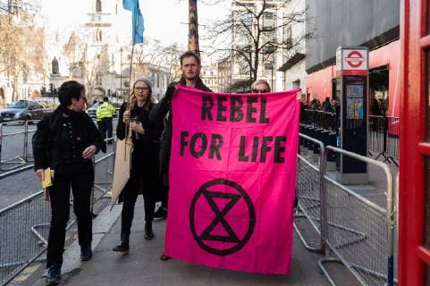 February 17, 2019 - London, Greater London, United Kingdom - Activists from Extinction Rebellion demonstrate outside London Fashion Week on 17 February, 2019. Protesters call for the British Fashion Council to influence fashion industry to stop the trend of excessive consumption and unsustainable growth in the face of climate change and ecological collapse. Textiles production contributes 1.2 billion tonnes of carbon emissions annually and textiles are the largest single source (34.8%) of microplastic pollution affecting marine life. London United Kingdom  - ZUMAn230 20190217_zaa_n230_203 Copyright: xWiktorxSzymanowiczx