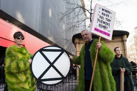 February 17, 2019 - London, Greater London, United Kingdom - Activists from Extinction Rebellion wear coats made of living grass during a demonstration outside London Fashion Week on 17 February, 2019. Protesters call for the British Fashion Council to influence fashion industry to stop the trend of excessive consumption and unsustainable growth in the face of climate change and ecological collapse. Textiles production contributes 1.2 billion tonnes of carbon emissions annually and textiles are the largest single source (34.8%) of microplastic pollution affecting marine life. London United Kingdom  - ZUMAn230 20190217_zaa_n230_211 Copyright: xWiktorxSzymanowiczx