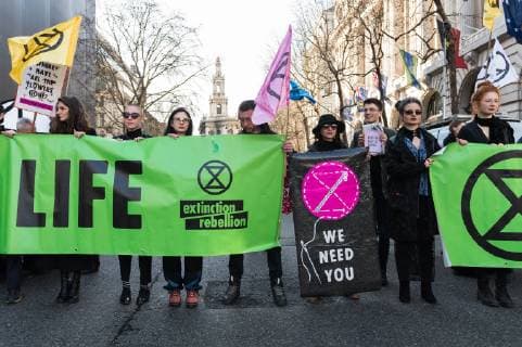 February 17, 2019 - London, Greater London, United Kingdom - Activists from Extinction Rebellion disrupt London Fashion Week by stopping traffic and creating gridlock between the event venues on 17 February, 2019. Protesters call for the British Fashion Council to influence fashion industry to stop the trend of excessive consumption and unsustainable growth in the face of climate change and ecological collapse. Textiles production contributes 1.2 billion tonnes of carbon emissions annually and textiles are the largest single source (34.8%) of microplastic pollution affecting marine life. London United Kingdom  - ZUMAn230 20190217_zaa_n230_212 Copyright: xWiktorxSzymanowiczx