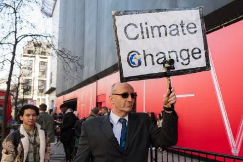 February 17, 2019 - London, Greater London, United Kingdom - Activist from Extinction Rebellion demonstrates outside London Fashion Week on 17 February, 2019. Protesters call for the British Fashion Council to influence fashion industry to stop the trend of excessive consumption and unsustainable growth in the face of climate change and ecological collapse. Textiles production contributes 1.2 billion tonnes of carbon emissions annually and textiles are the largest single source (34.8%) of microplastic pollution affecting marine life. London United Kingdom  - ZUMAn230 20190217_zaa_n230_202 Copyright: xWiktorxSzymanowiczx