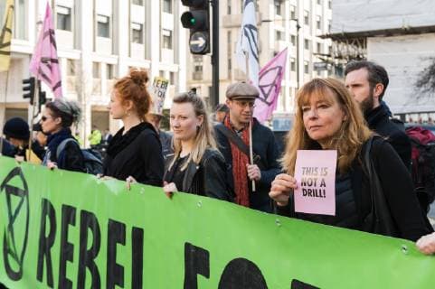 February 17, 2019 - London, Greater London, United Kingdom - Activists from Extinction Rebellion disrupt London Fashion Week by stopping traffic and creating gridlock between the event venues on 17 February, 2019. Protesters call for the British Fashion Council to influence fashion industry to stop the trend of excessive consumption and unsustainable growth in the face of climate change and ecological collapse. Textiles production contributes 1.2 billion tonnes of carbon emissions annually and textiles are the largest single source (34.8%) of microplastic pollution affecting marine life. London United Kingdom  - ZUMAn230 20190217_zaa_n230_204 Copyright: xWiktorxSzymanowiczx