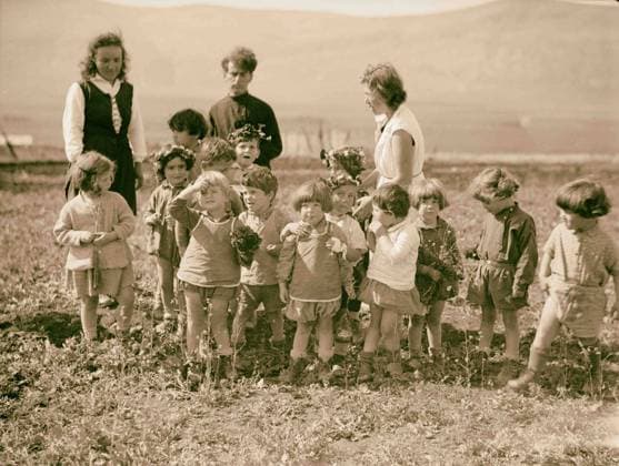 The Keren Hayesod. Agricultural Colonies on Plain of Esdraelon The Emek. Zionist children at play. A spring group. Children picking wild flowers. 1920, Middle East, Israel  Copyright: LisztxCollection LCME180713_12538