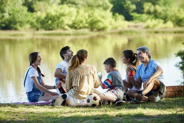 Family enjoying picnic near lake  Copyright: EricxAudras B51447937