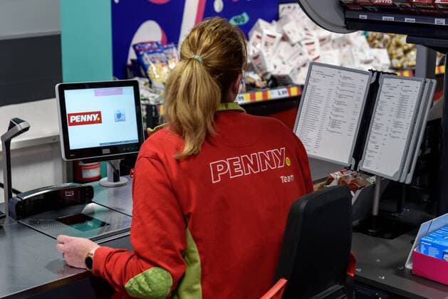 Employee at the supermarket checkout on the occasion of the presentation of the campaign Save precious things against food waste in a PENNY market in Boxhagener Strasse in Berlin Friedrichshain snapshot photography F Boillot