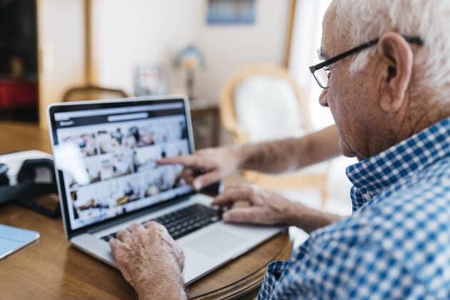 Adult grandson teaching his grandfather to use laptop model released Symbolfoto property released  JRFF01420