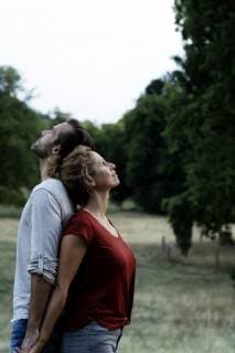 Happy couple standing in nature, back to back model released Symbolfoto  HHLMF00588