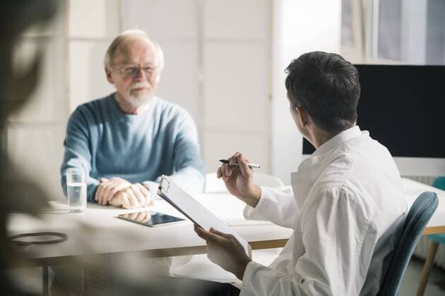 Doctor talking to senior patient in medical practice model released Symbolfoto property released  JOSF02775