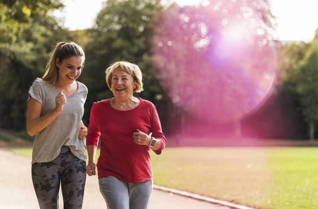 Granddaughter and grandmother having fun, jogging together in the park model released Symbolfoto  UUF16055