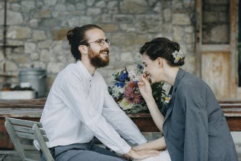 Happy bride and groom sitting at table model released Symbolfoto  ALBF00684
