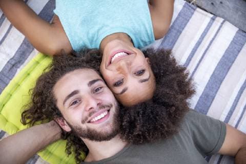Portrait of happy couple lying on a blanket outdoors model released Symbolfoto  FMKF05285
