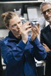 Manager and skilled worker in high tech enterprise, checking machine parts model released Symbolfoto property released  KNSF04936