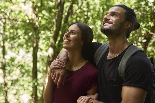 Spain, Canary Islands, La Palma, happy couple standing in a forest looking up model released Symbolfoto  PACF00149