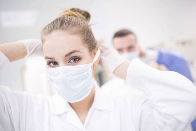 Portrait of lab technician putting on mask model released Symbolfoto property released  WESTF23629
