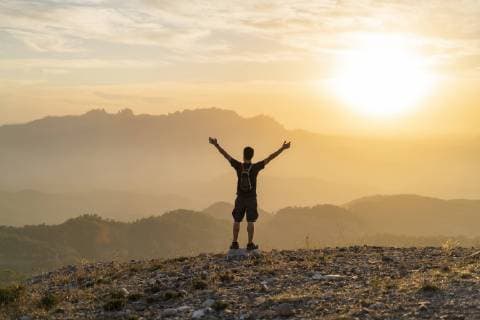 Spain, Barcelona, Natural Park of Sant Llorenc, man hiking and cheering at sunset model released Symbolfoto  AFVF01890