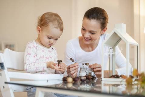 Mother and little daughter tinkering autumnal decorative house at home model released Symbolfoto property released  DIGF05589