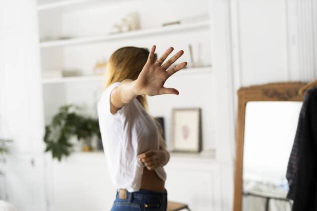 Abuse and violence against women, woman raising hand at home model released Symbolfoto property released  ERRF00059