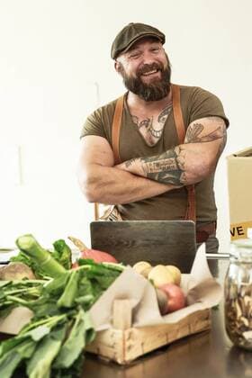Owner of a delivery service for organic vegetables, standing proud in his kitchen model released Symbolfoto property released  REAF00376