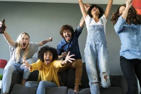 Excited fans watching tv and cheering model released Symbolfoto property released  VABF01917