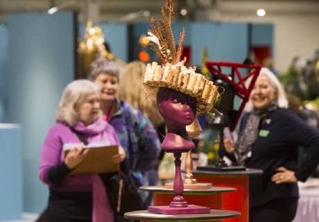 (190308) -- TORONTO, March 8, 2019 (Xinhua) -- People look at hats made from plants during the 2019 Canada Blooms in Toronto, Canada, March 8, 2019. The annual world-class event connects people to the joys and benefits of nature through experiences with gardens and flowers from March 8 to 17. (Xinhua Zou Zheng) CANADA-TORONTO-CANADA BLOOMS 