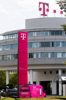 Company logo of the German Telekom at the headquarters in Bonn Company vehicle as an advertising medium for the most modern mobile network Company logo of the German Telekom at the headquarters in Bonn Company vehicle as an advertising medium for the most modern mobile network  1083401606
