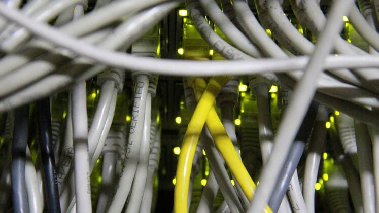 Utp cable with RJ 45 on working server machine Close up of UTP cables with RJ 45 on working Server machine  1069500165