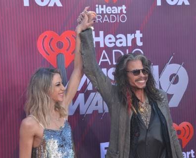 (L-R) Aimee Preston and Steven Tyler arrive for the sixth annual iHeartRadio Music Awards at the Microsoft Theater in Los Angeles, California on March 14, 2019. The annual award show will broadcast live on FOX.  LAP20190314147 JIMxRUYMEN