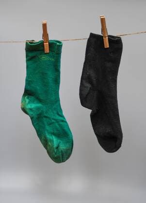 A green and a black sock hanging from a clothesline In Baden Württemberg, greens and blacks make up the state government Photo Winfried Rothermel
