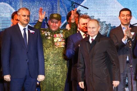 SEVASTOPOL, RUSSIA - MARCH 18, 2018: Head of Crimea Sergei Aksyonov (L front) and Russia s President Vladimir Putin (R front) attend a concert marking the 5th anniversary of the Crimean status referendum and its reunification with Russia in Sevastopol. Sergei Malgavko TASS  TS0A500C
