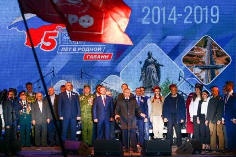 SEVASTOPOL, RUSSIA - MARCH 18, 2018: Russia s President Vladimir Putin (C front) attends a concert marking the 5th anniversary of the Crimean status referendum and its reunification with Russia in Sevastopol. Sergei Malgavko TASS  TS0A500F