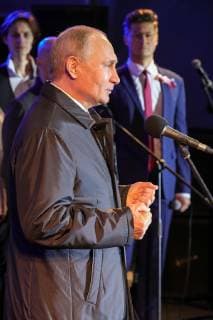SEVASTOPOL, RUSSIA - MARCH 18, 2018: Russia s President Vladimir Putin (front) speaks at a concert marking the 5th anniversary of the Crimean status referendum and its reunification with Russia in Sevastopol. Mikhail Klimentyev Russian Presidential Press and Information Office TASS  TS0A5022