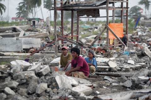 A Family Crouches In The Rubble Of Their Destroyed Home Close To The Coast In Meulaboh, After The Indian Ocean Tsunami; Aceh Province, Indonesia  Copyright: JimxHolmes 2382635