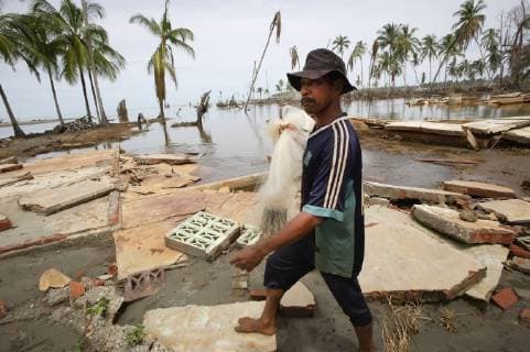 A Fisherman Fishing In Coastal Waters Near Lamno, Surrounded By Debris Of Broken Trees And Houses After The Indian Ocean Tsunami In 2004; Aceh Province, Sumatra, Indonesia  Copyright: JimxHolmes 2382769