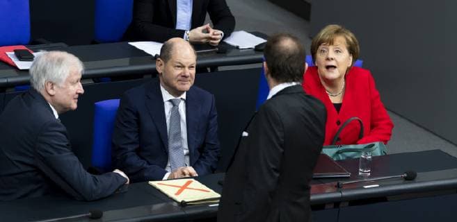 Chancellor Angela Merkel R Finance Minister Olaf Scholz C and Interior Minister Horst Seehofer L with Alexander Dobrindt from behind during the 89th plenary session in the Bundestag in Berlin on 21 March 2019 89th session and government declaration in the Bundestag