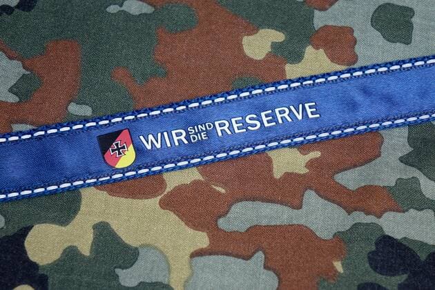 Lanyard on a camouflage lanyard Lanyard on a camouflage lanyard 28 03 2019 Borkwalde Brandenburg A lanyard of the reservist association lies on a camouflage lanyard