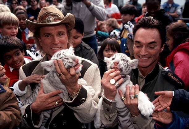 Siegfried and Roy with tiger cubs in New York Las Vegas performers Siegfried Fischbacher, left, and Roy Horn, known as Siegfried and Roy appear in a rare New York City event with two of their white tiger cubs and a gaggle of New York City school kids in this circa 1996 file photo. Former animal handler for the duo, Chris Lawrence, said in a recent interview that handling errors by Roy Horn resulted in the 2003 attack on stage in Las Vegas by the white tiger Mantacore. (  RichardxB.xLevine