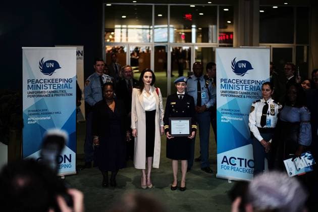 (190330) -- UNITED NATIONS, March 30, 2019 -- Angelina Jolie (C), a special envoy for the United Nations Refugee Agency (UNHCR), poses for a photo with Lieutenant Commander Marcia Andrade Braga (3rd L Center), UN Military Gender Advocate of the Year, at the UN headquarters in New York March 29, 2019. There is still much more to do to increase the number of women in the ranks of the UN peacekeeping missions, said Hollywood actress Angelina Jolie on Friday at the UN Headquarters in New York. ) UN-PEACEKEEPING-ANGELINA JOLIE LIxMUZI 