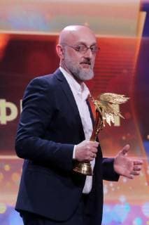 MOSCOW, RUSSIA â€“ MARCH 30, 2019: Director Levan Leo Gabriadze accepts an award for Best Animated Film for his animated documentary film Rezo at the 32nd Nika Film Award Ceremony. Vyacheslav Prokofyev TASS  TS0A6701