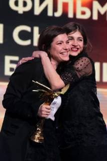 MOSCOW, RUSSIA â€“ MARCH 30, 2019: Director Darya Zhuk (L) accepts an award for Best CIS, Georgia, and Baltic States Film for her movie The Crystal Swan at the 32nd Nika Film Award Ceremony. Vyacheslav Prokofyev TASS  TS0A6719