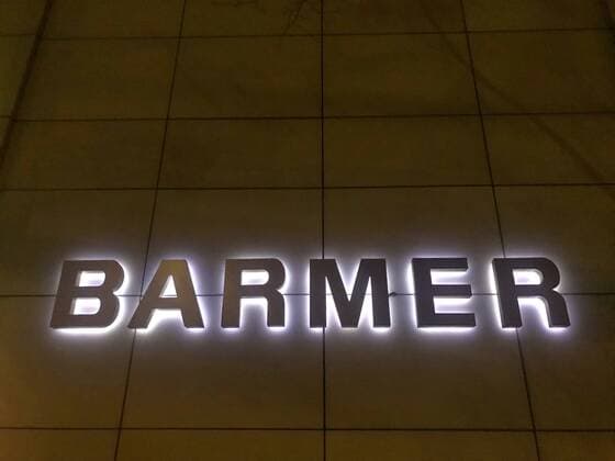Illuminated Barmer Health Insurance logo on a wall 31 01 2019