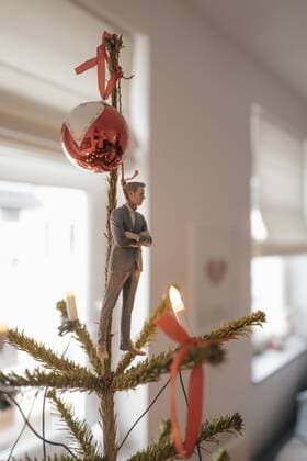 Businessman figurine hanging on a Christmas tree at home model released Symbolfoto property released  FLAF00153