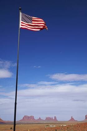 United States, Utah Arizona Border, Navajo Nation, Monument Valley, American flag and rock formations  Copyright: xDavidxWallx US03 DWA0290