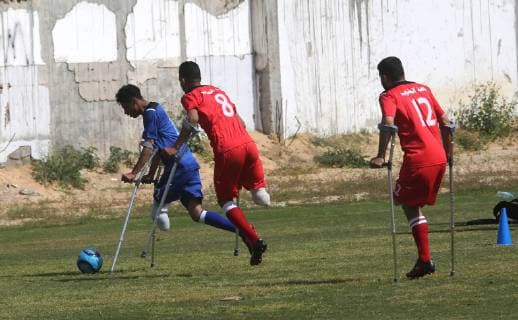 April 13, 2019 - Gaza City, Gaza Strip, Palestinian Territory - Palestinian amputees using crutches play a football match during the first football tournament for amputees, at Palestine Stadium in Gaza city, on April 13, 2019. More than 125 have had amputations shot by Israeli forces during a year of weekly mass protests along the Gaza border, according to Palestinian figures Gaza City Palestinian Territory - ZUMAap3_ 20190413_zaf_ap3_068 Copyright: xAshrafxAmrax
